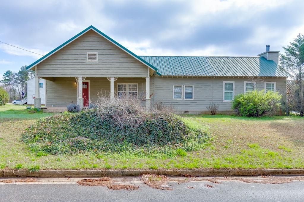 a front view of house with a garden