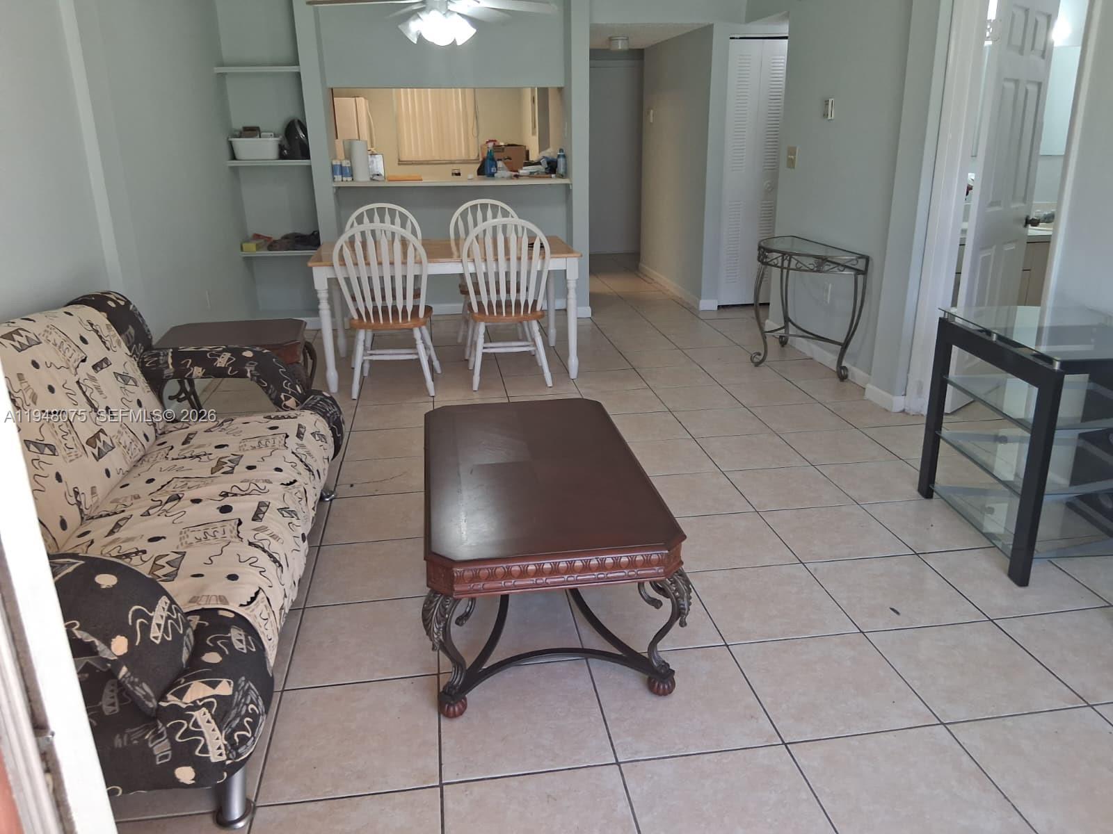 19791 Southwest 114th Avenue, Unit 135 Miami, FL 33157 - Photo 3 of 9 a view of a livingroom with furniture and a floor to ceiling window