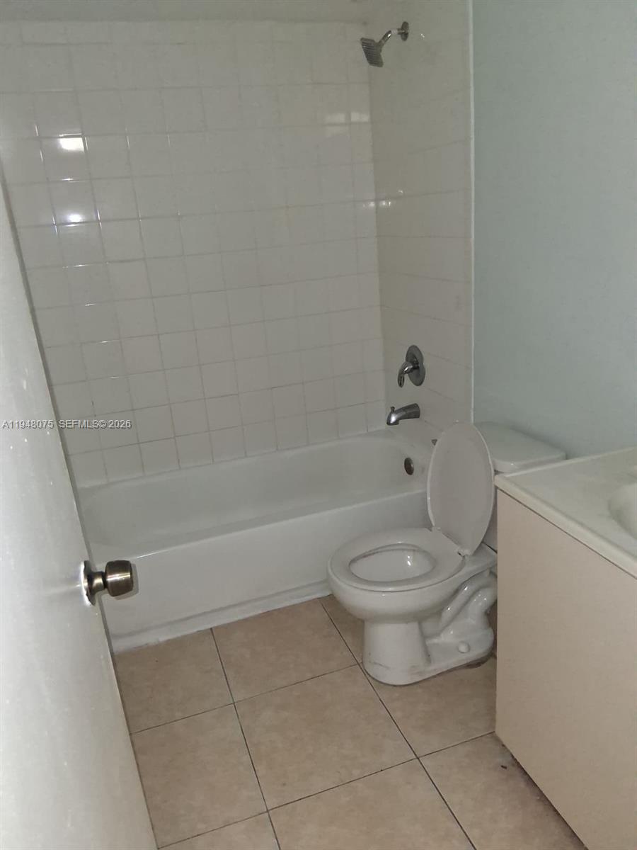 19791 Southwest 114th Avenue, Unit 135 Miami, FL 33157 - Photo 7 of 9 a bathroom with a toilet a sink and bathtub
