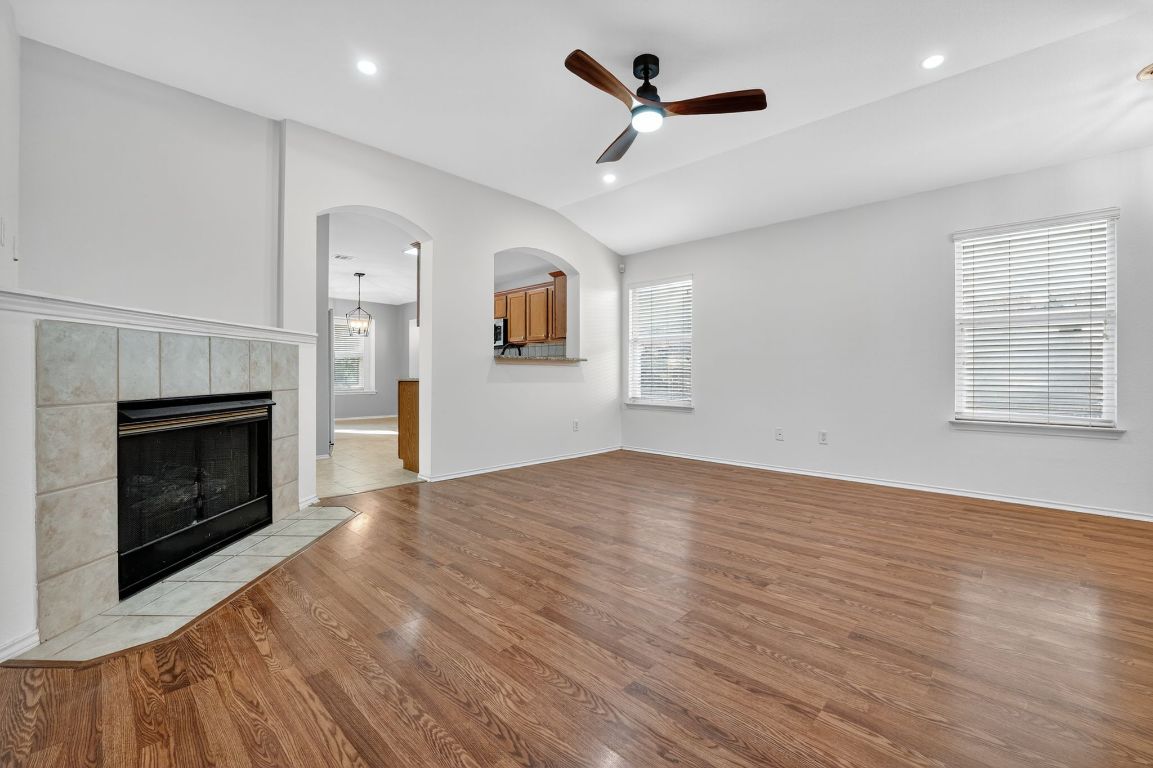 1502 McDowell Bend Leander, TX 78641 - Photo 12 of 31 a view of empty room with wooden floor and fireplace