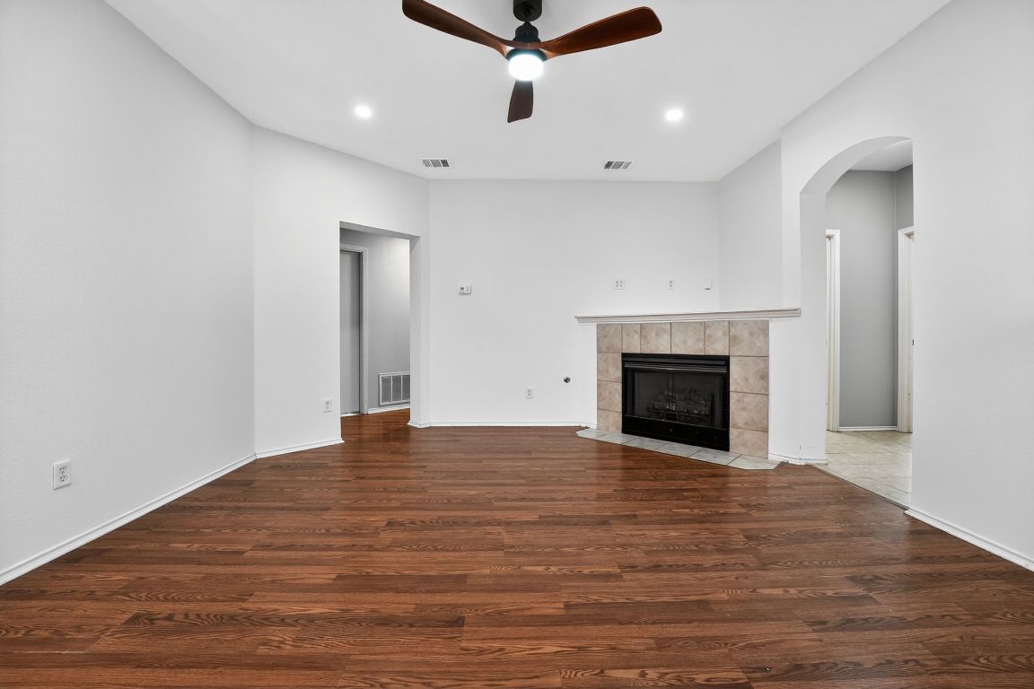 1502 McDowell Bend Leander, TX 78641 - Photo 15 of 31 a view of an empty room with wooden floor fireplace and a window