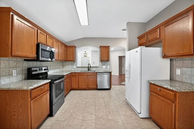 a kitchen with a sink stove and microwave