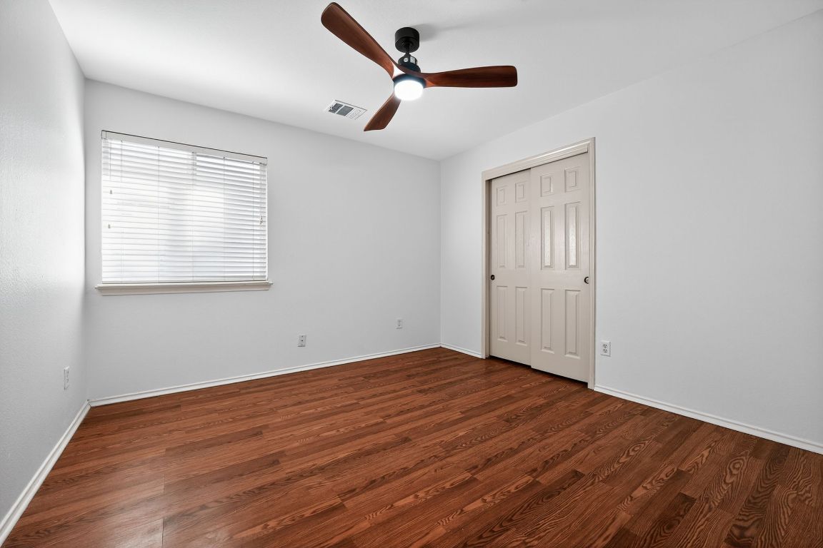 1502 McDowell Bend Leander, TX 78641 - Photo 22 of 31 a view of empty room with wooden floor and fan