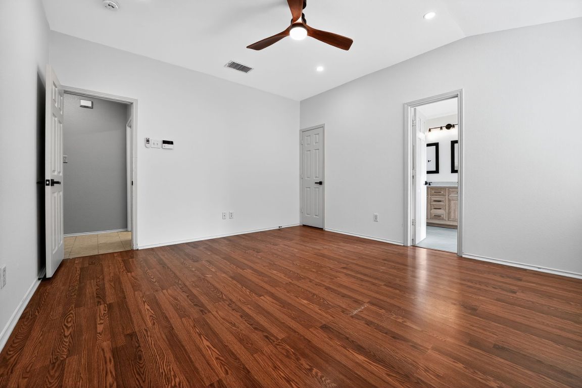 1502 McDowell Bend Leander, TX 78641 - Photo 25 of 31 a view of empty room with wooden floor and ceiling fan