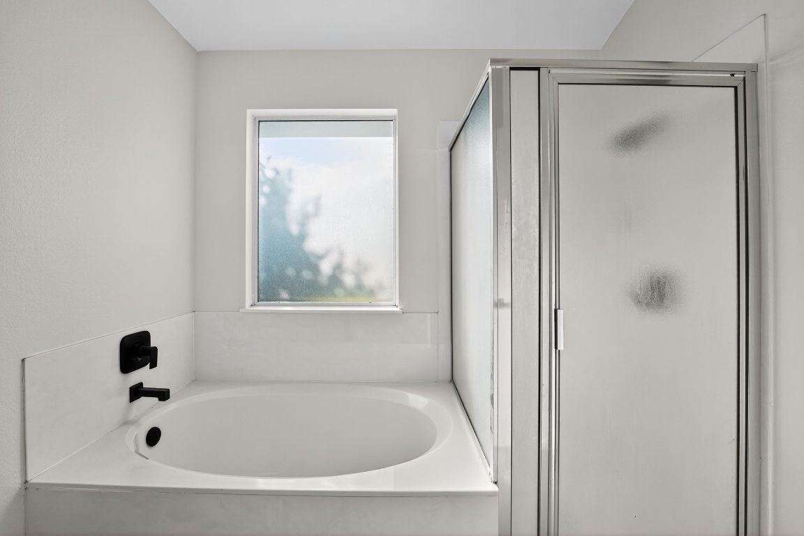 1502 McDowell Bend Leander, TX 78641 - Photo 27 of 31 a white bath tub sitting next to a small window