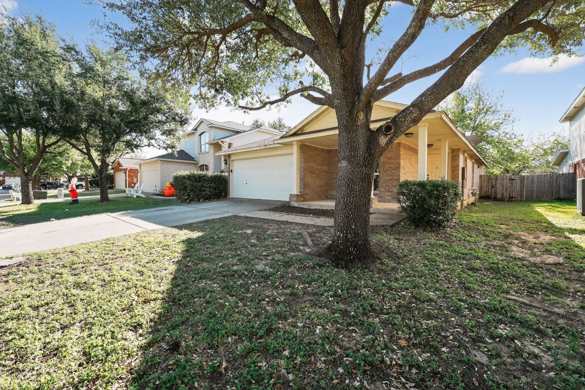 1502 McDowell Bend Leander, TX 78641 - Photo 3 of 31 a front view of a house with a yard and garage