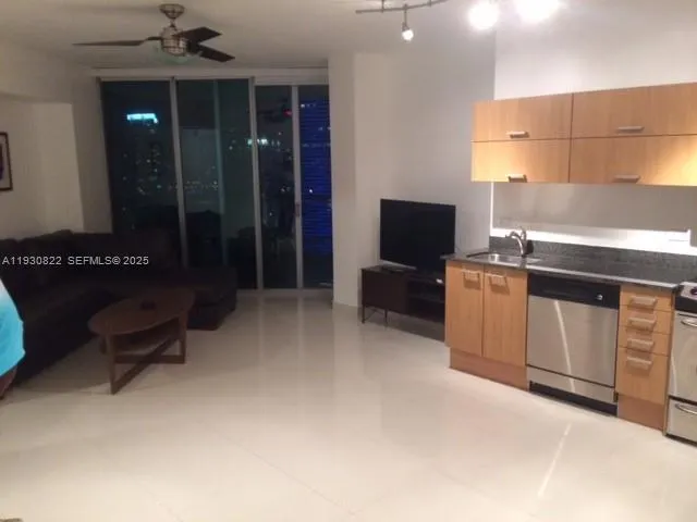 a kitchen with stainless steel appliances granite countertop a refrigerator a sink a stove a microwave a counter top and cabinets