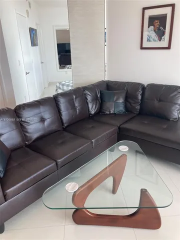 a dining room with furniture and a potted plant