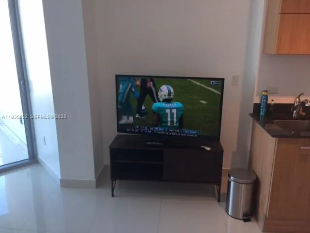 a living room with furniture and a dining table with projector