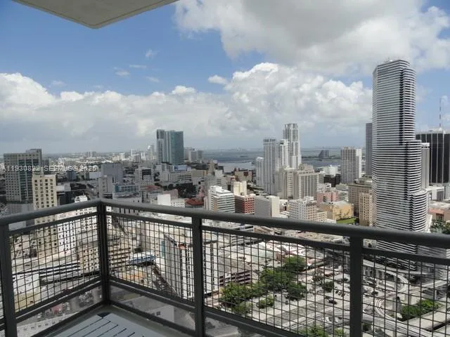 a view of a living room with furniture and floor to ceiling window