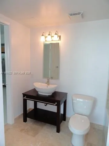 a bathroom with a sink toilet a mirror and shower