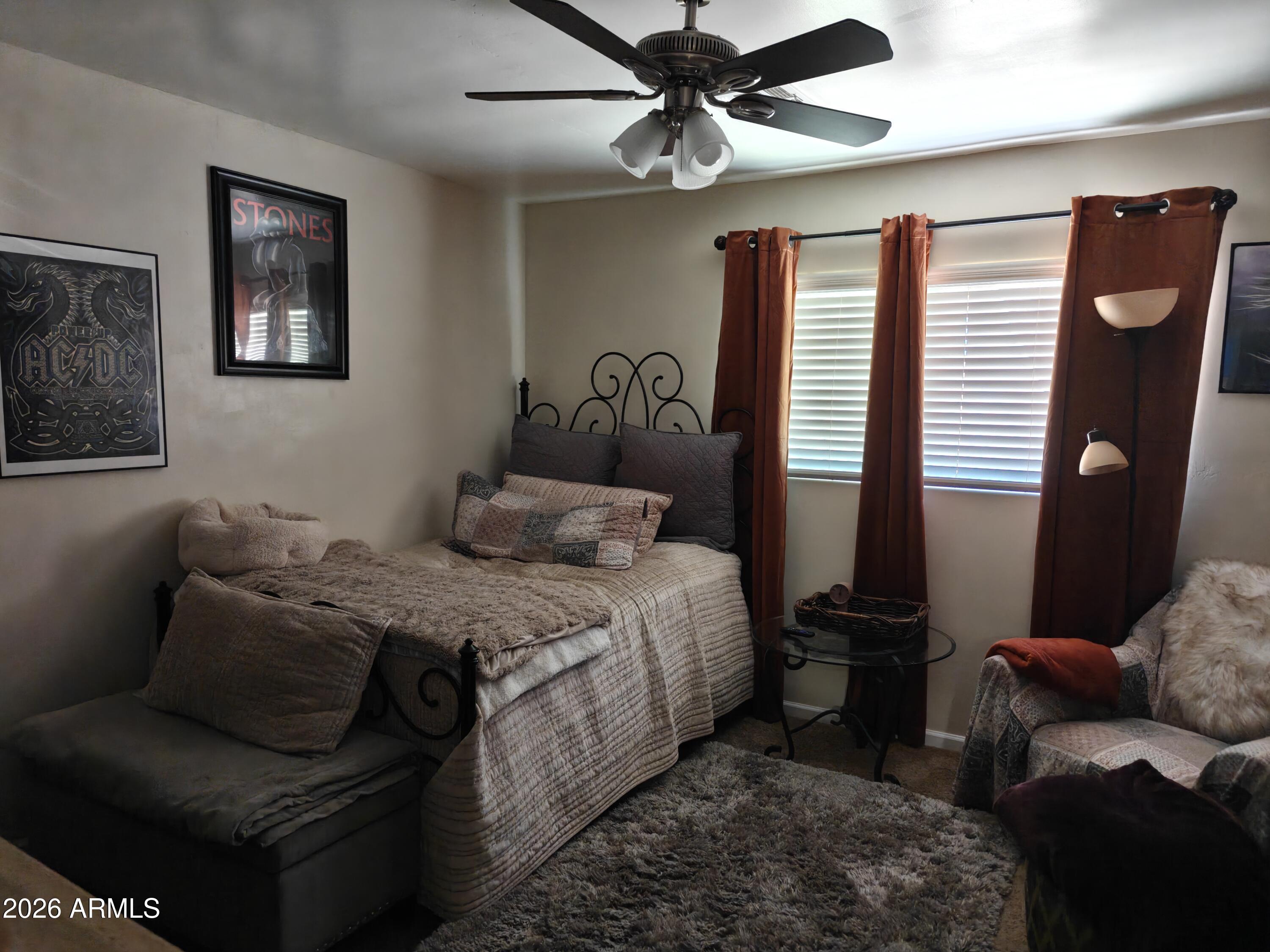2417 West Roughrider Road New River, AZ 85087 - Photo 19 of 61 a bedroom with bed couch and window