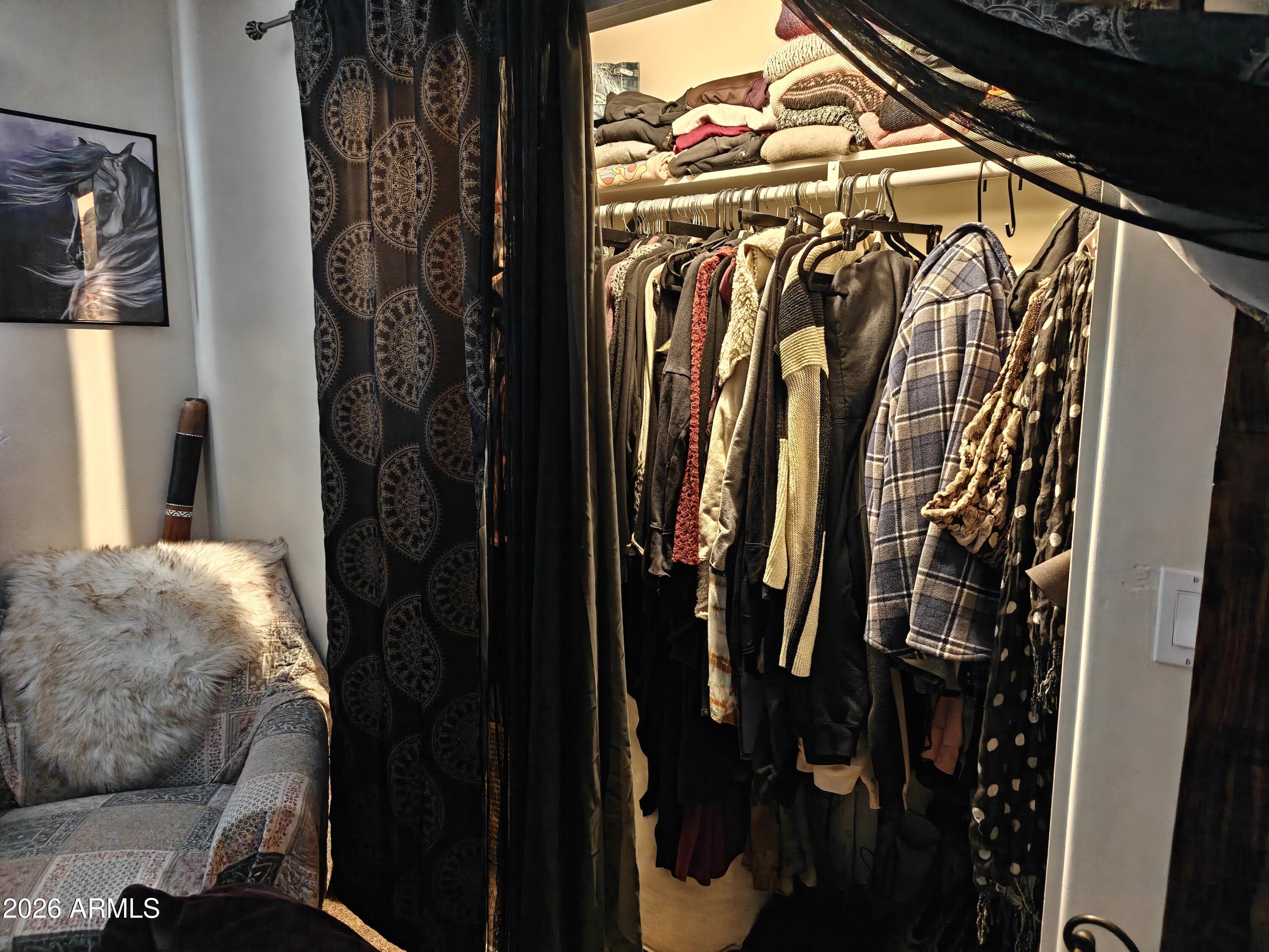 2417 West Roughrider Road New River, AZ 85087 - Photo 20 of 61 a view of walk in closet with clothes