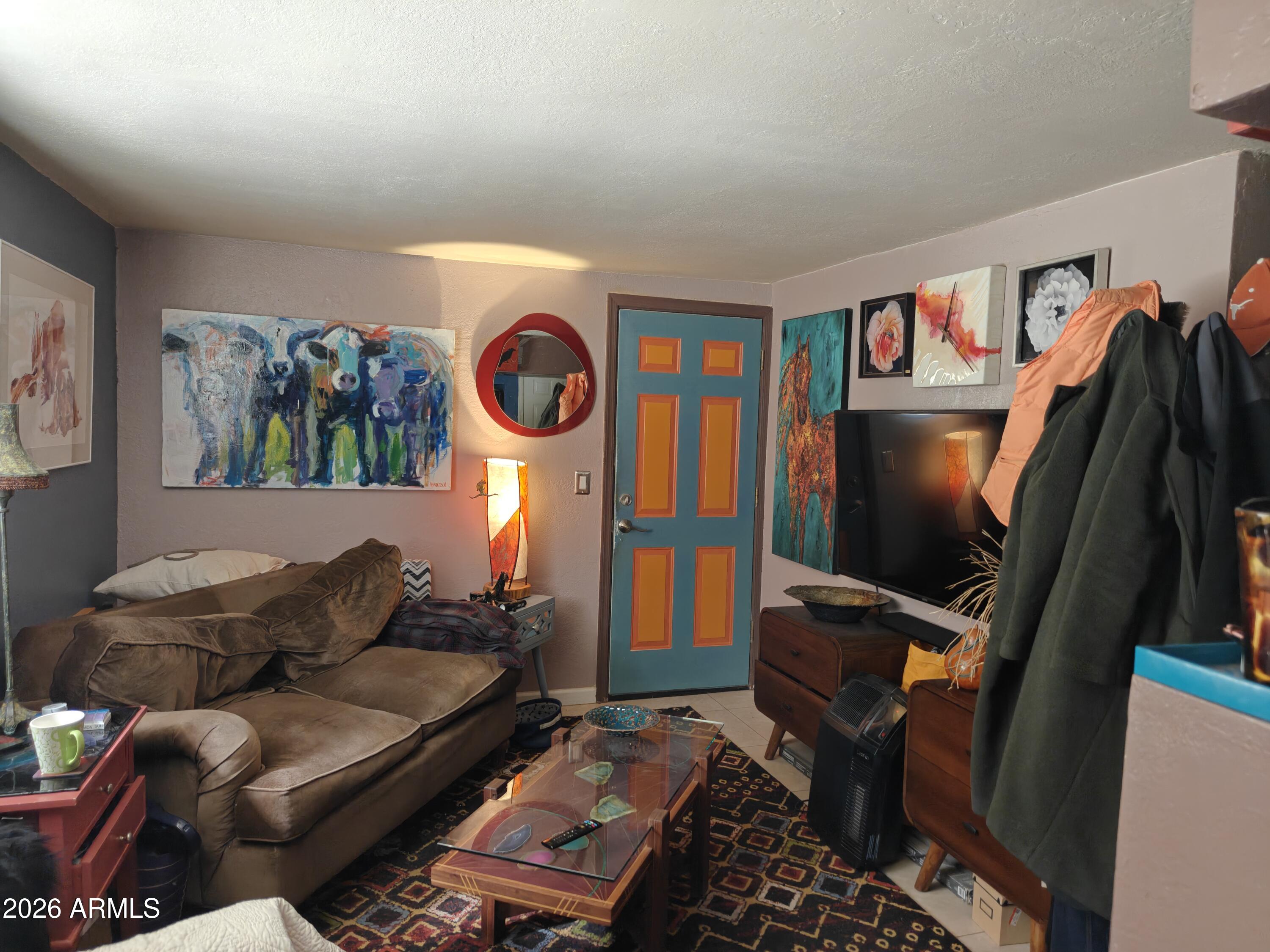2417 West Roughrider Road New River, AZ 85087 - Photo 31 of 61 a living room with furniture and a flat screen tv