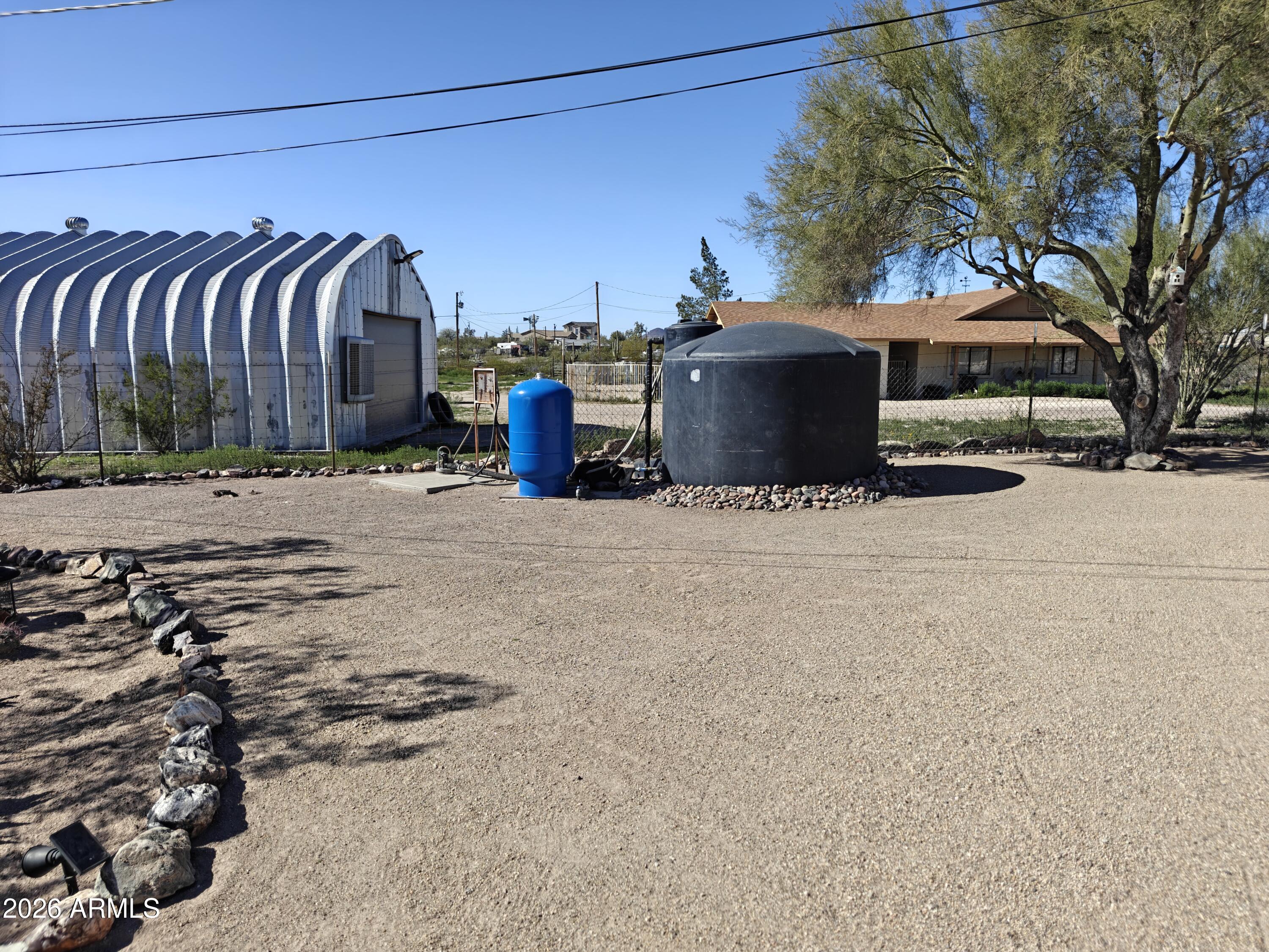 2417 West Roughrider Road New River, AZ 85087 - Photo 43 of 61 a view of a house with a big yard and large trees
