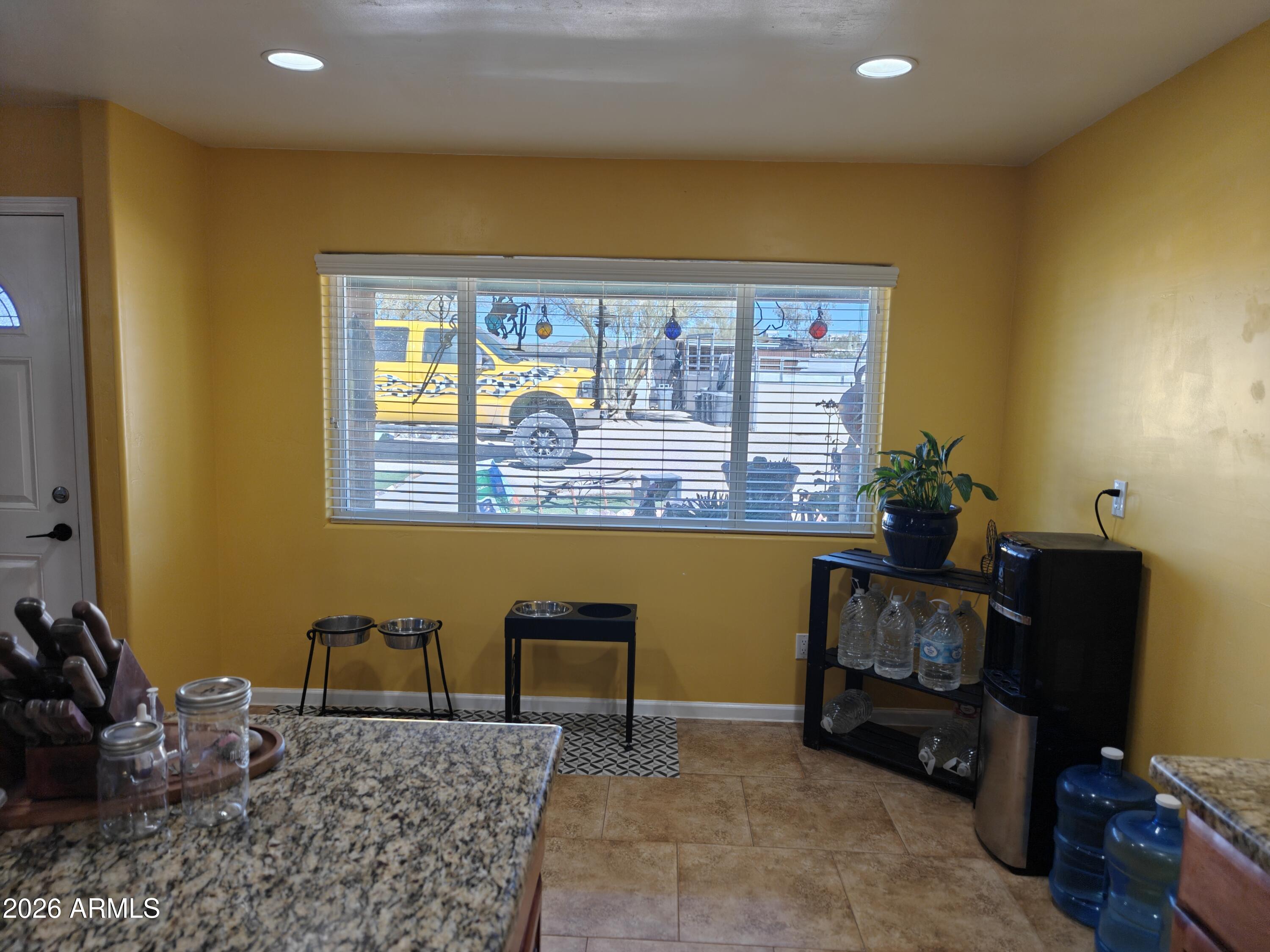 2417 West Roughrider Road New River, AZ 85087 - Photo 7 of 61 a living room with furniture and a window