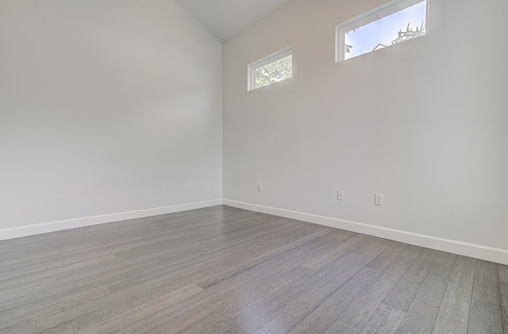 2406 East 16th Street Austin, TX 78702 - Photo 21 of 39 a view of an empty room with wooden floor and a window