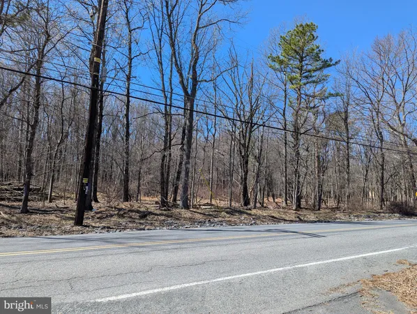 a view of a road with a white house