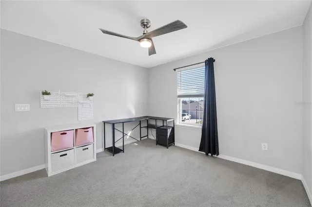 a bedroom with bed and a flat tv screen on dresser