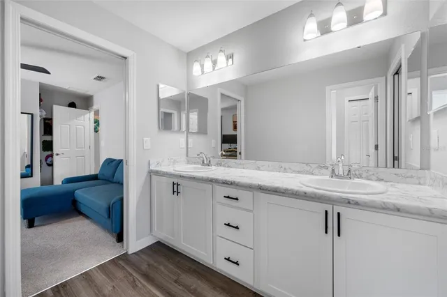 a bathroom with a granite countertop sink a toilet and bathtub