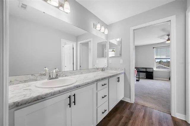 a view of a house with a big yard and potted plants