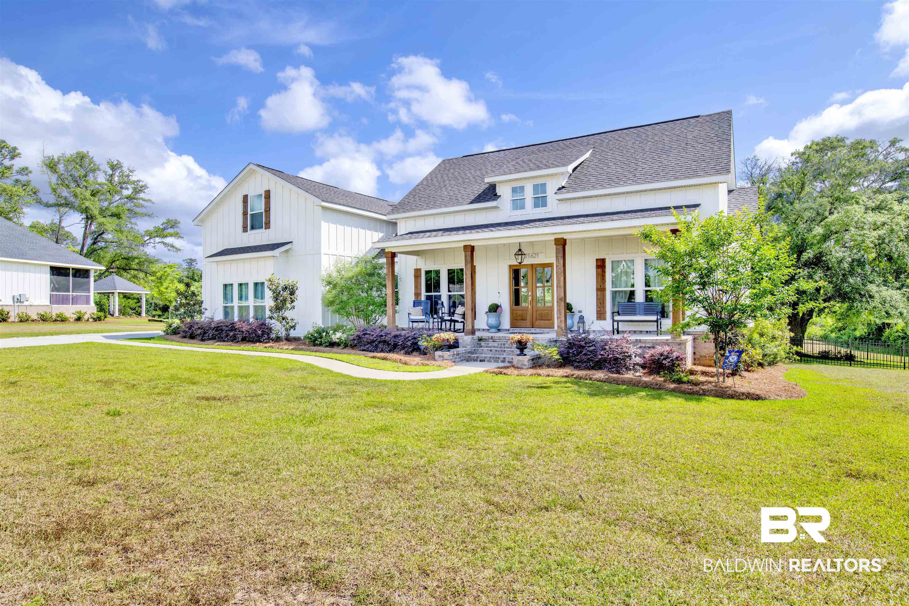 21621 Veranda Boulevard Fairhope, AL 36532 - Photo 12 of 51 View of front of house with covered porch, roof with shingles, french doors, and a front yard