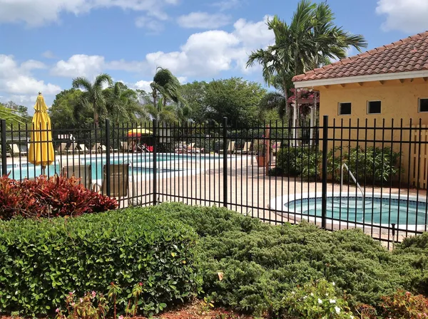 a view of a house with a small yard and wooden fence
