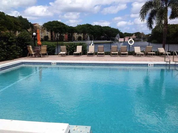 a house view with swimming pool and sitting space
