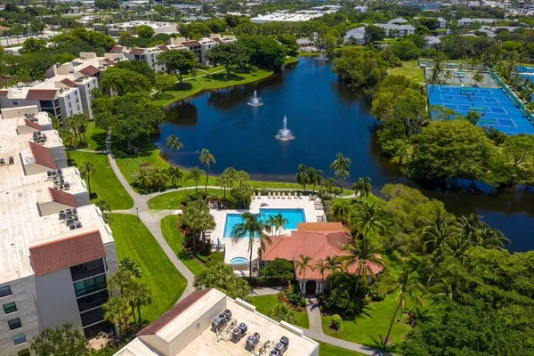 an aerial view of a house with a yard and lake view
