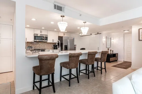 a large kitchen with a table and chairs
