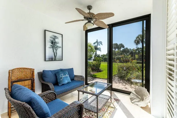 a living room with furniture and a floor to ceiling window