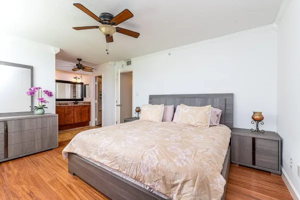 a spacious bedroom with a bed and a dresser