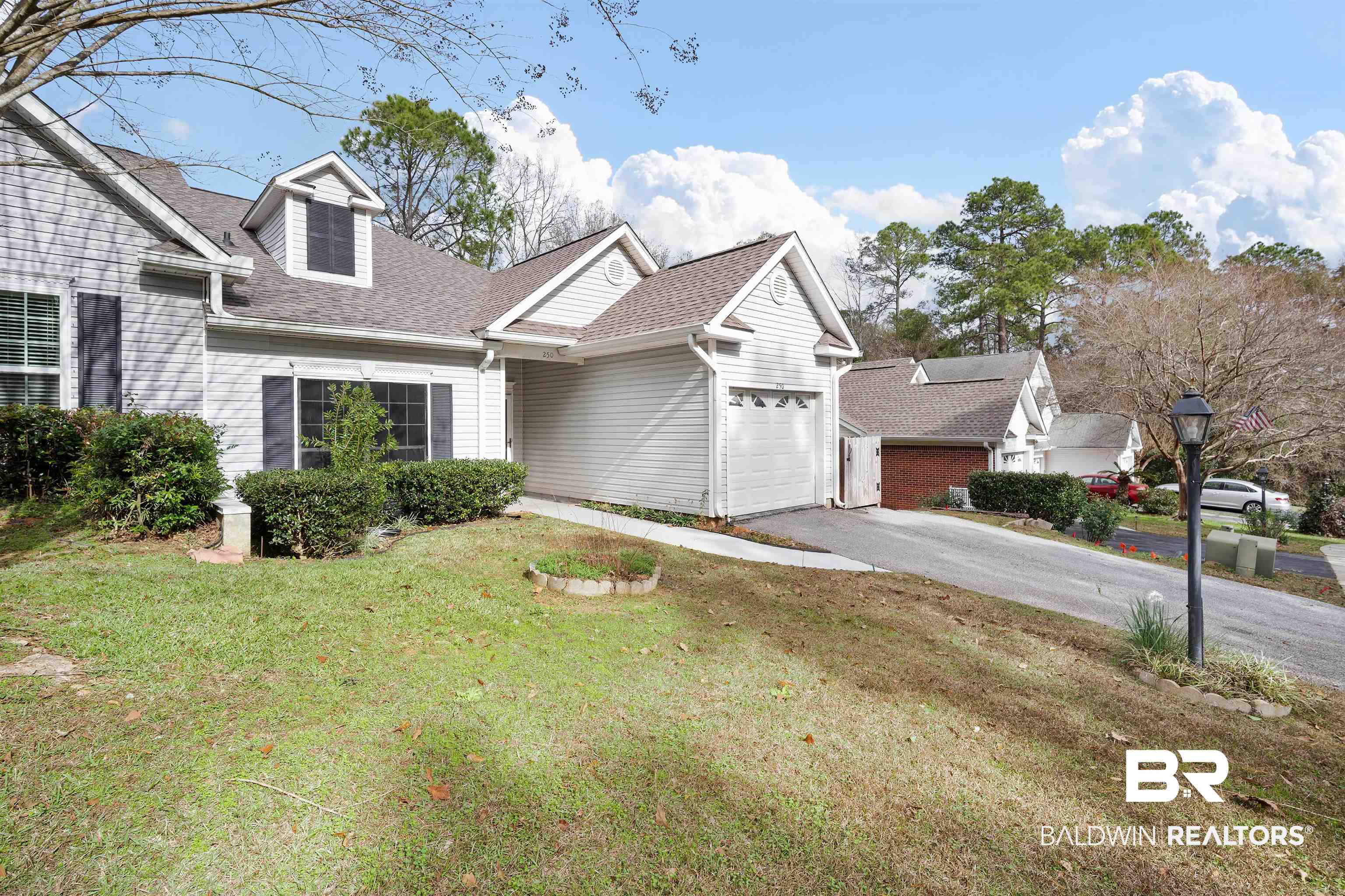250 North Spring Lake Drive Mobile, AL 36695 - Photo 28 of 29 View of front of house with driveway, a shingled roof, an attached garage, and a front lawn