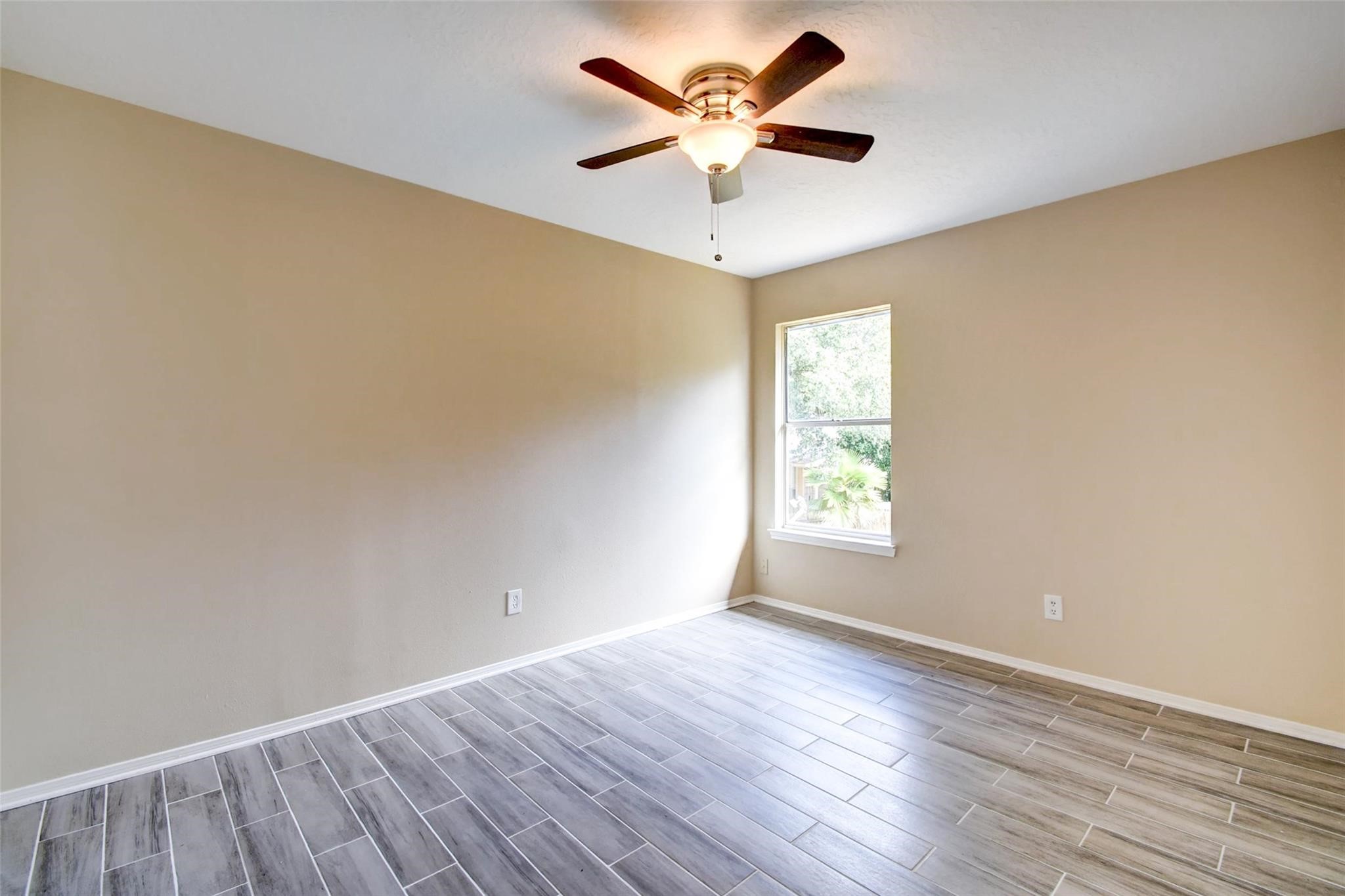 16811 Anna Green Street Houston, TX 77084 - Photo 23 of 27 an empty room with wooden floor and windows