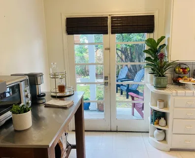 a kitchen with a large window appliances and cabinets