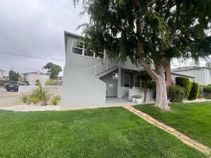 a view of house with backyard and garden