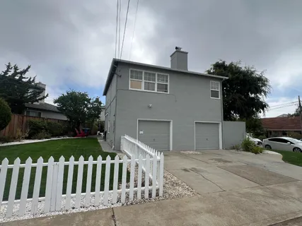 a front view of a house with a garden
