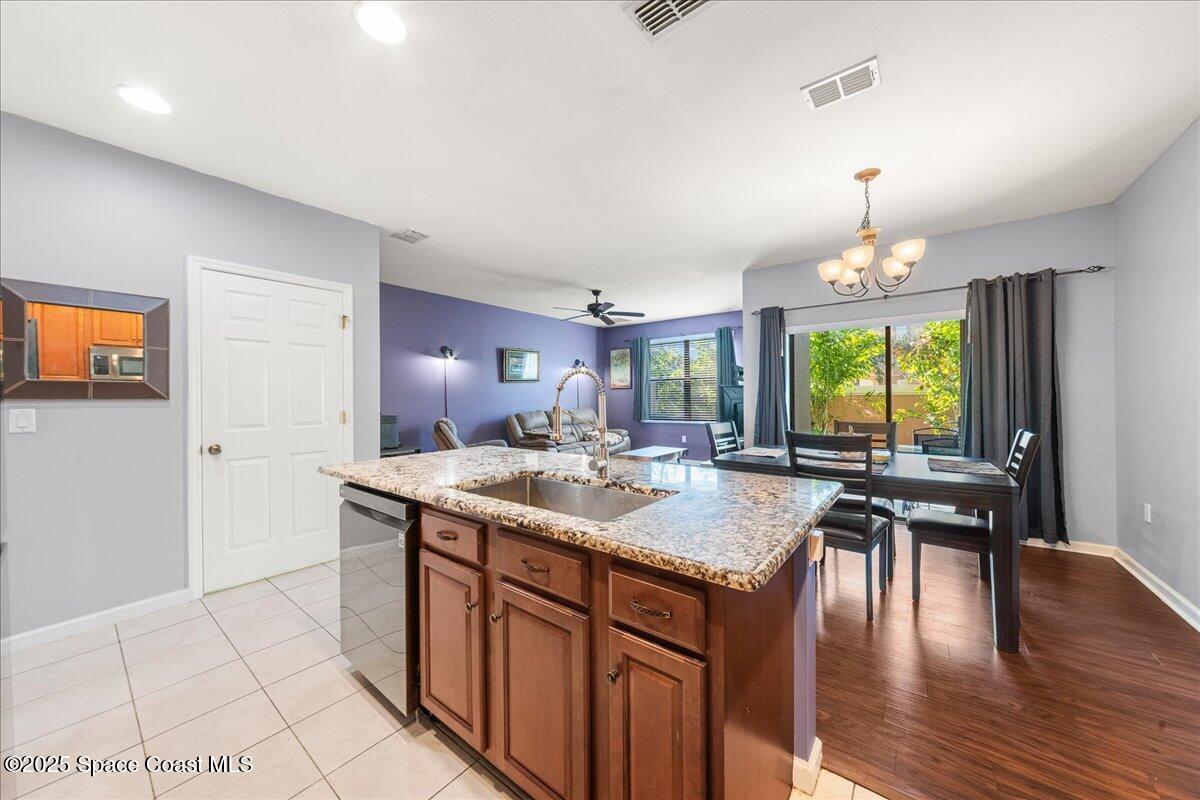 1345 Lara Circle, Unit 102 Rockledge, FL 32955 - Photo 11 of 34 a kitchen with a stove a sink a counter space and a dining table