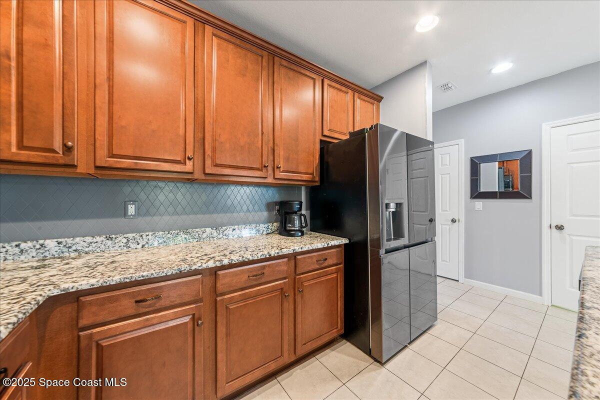 1345 Lara Circle, Unit 102 Rockledge, FL 32955 - Photo 12 of 34 a kitchen with stainless steel appliances granite countertop a refrigerator and cabinets