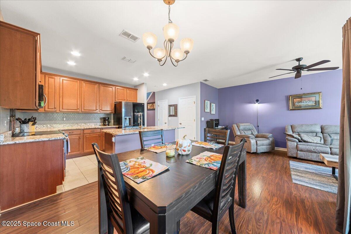 1345 Lara Circle, Unit 102 Rockledge, FL 32955 - Photo 14 of 34 a view of a dining room with furniture window and wooden floor