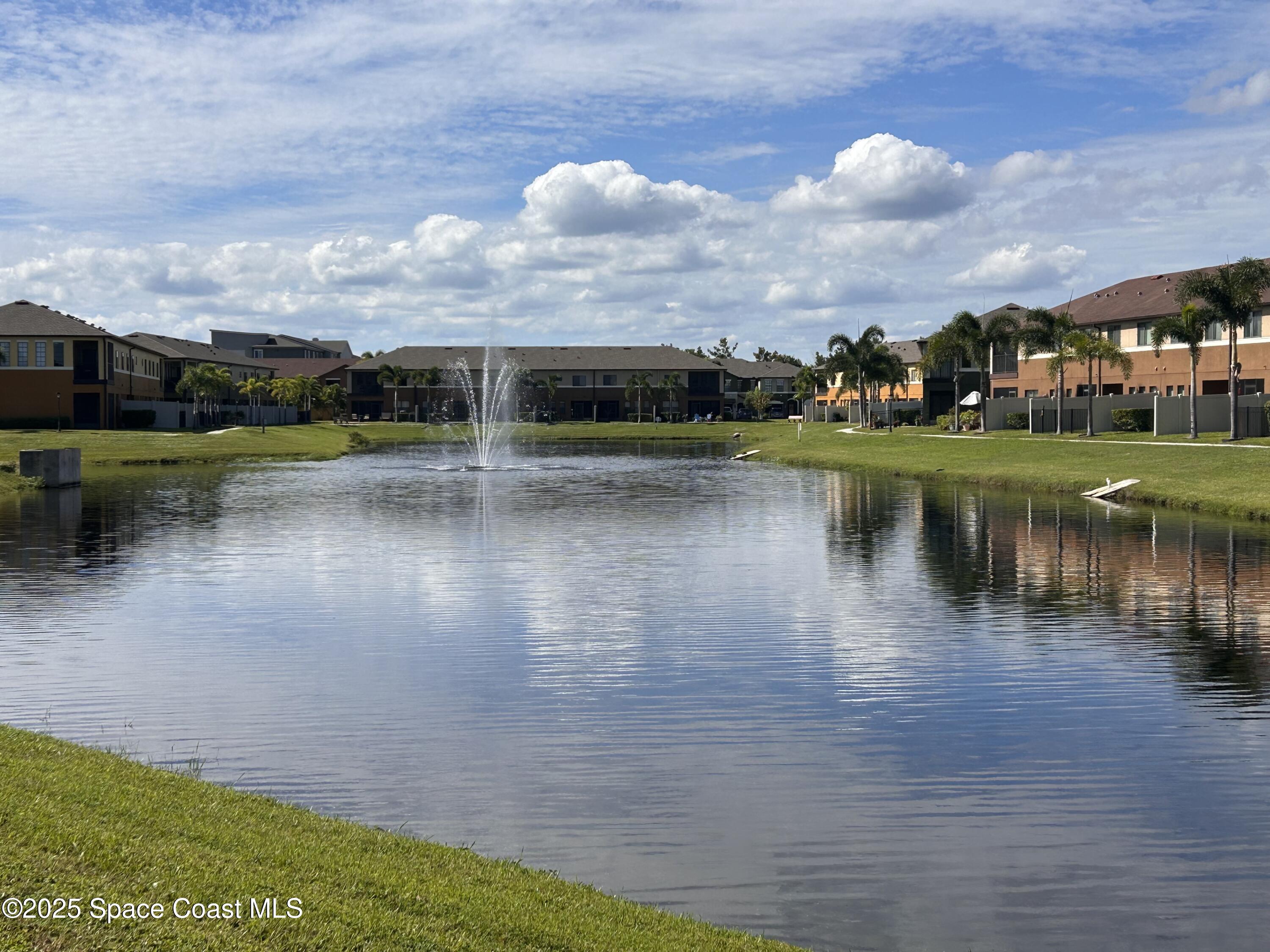 1345 Lara Circle, Unit 102 Rockledge, FL 32955 - Photo 31 of 34 a view of a lake with houses in the back