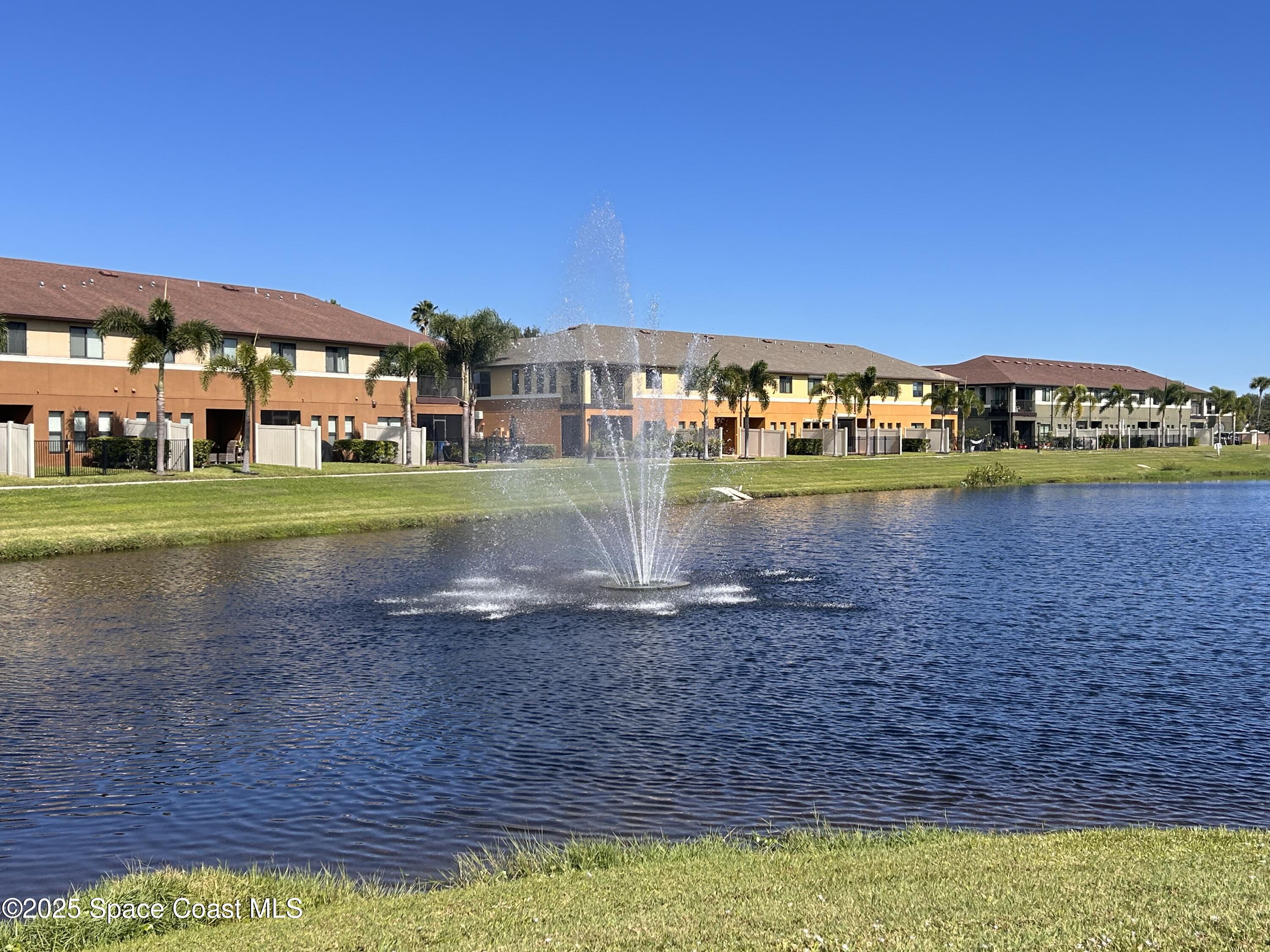 1345 Lara Circle, Unit 102 Rockledge, FL 32955 - Photo 33 of 34 a view of a big yard with a house in the background