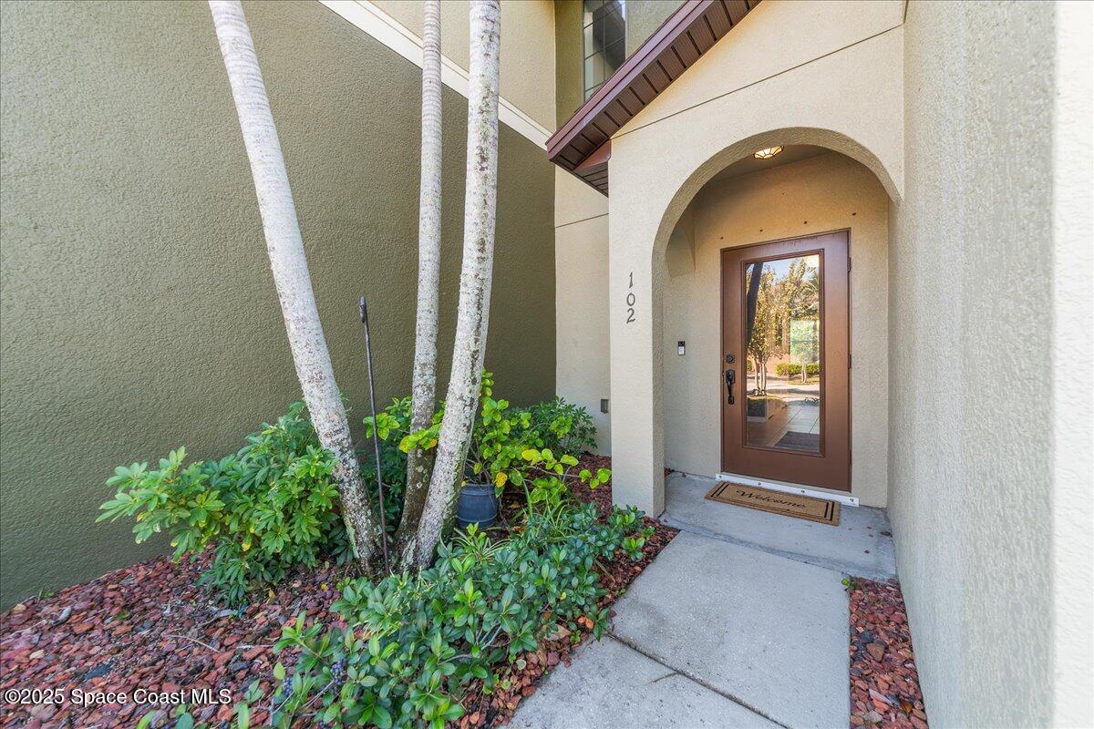 1345 Lara Circle, Unit 102 Rockledge, FL 32955 - Photo 4 of 34 a view of a brick house with potted plants