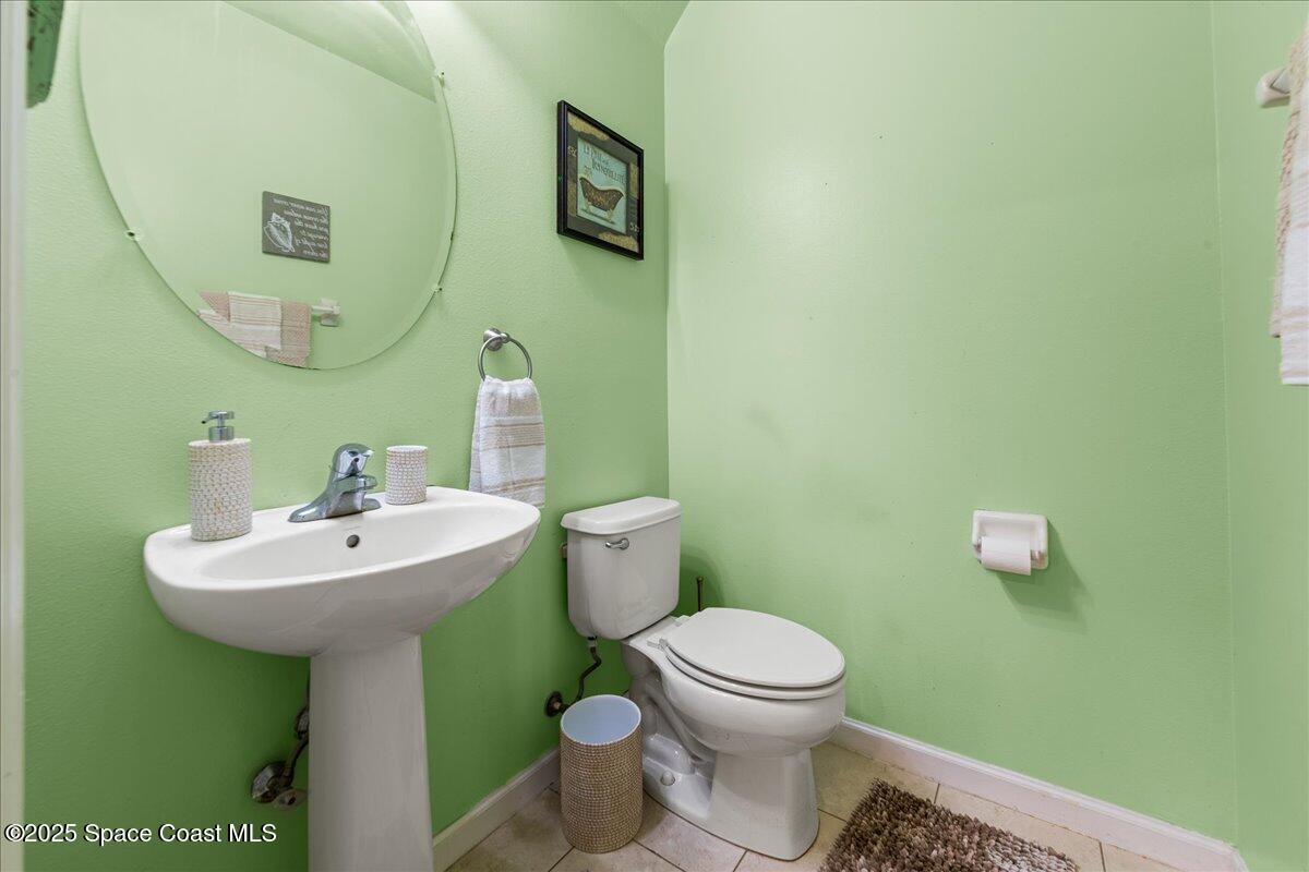 1345 Lara Circle, Unit 102 Rockledge, FL 32955 - Photo 7 of 34 a bathroom with a sink a mirror and a toilet