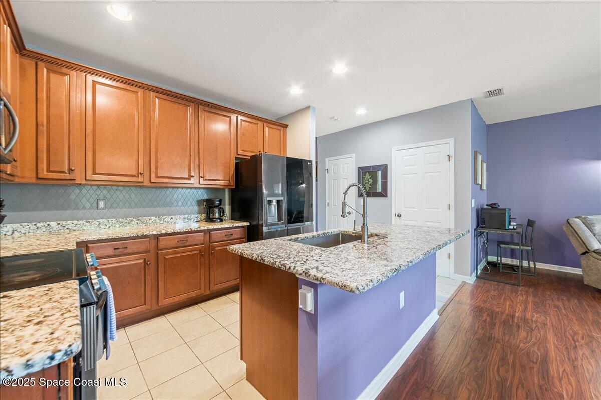 1345 Lara Circle, Unit 102 Rockledge, FL 32955 - Photo 10 of 34 a kitchen with stainless steel appliances granite countertop refrigerator sink and cabinets