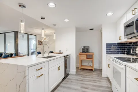 a kitchen with a sink stove and cabinets