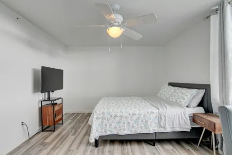 a bedroom with a bed and a tv on table
