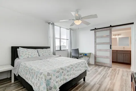 a bedroom with a bed and a chandelier