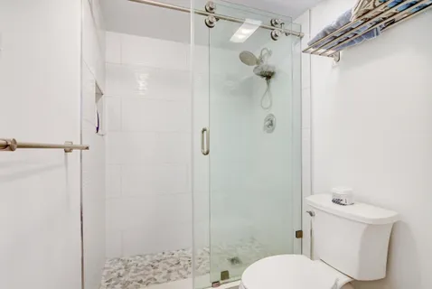 a white toilet sitting next to a bathroom