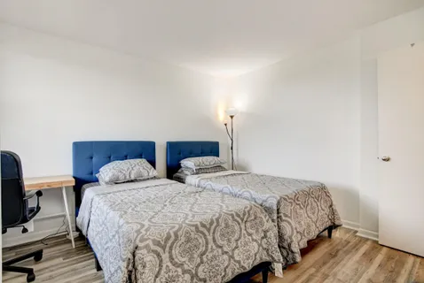 a bedroom with two beds and a couch